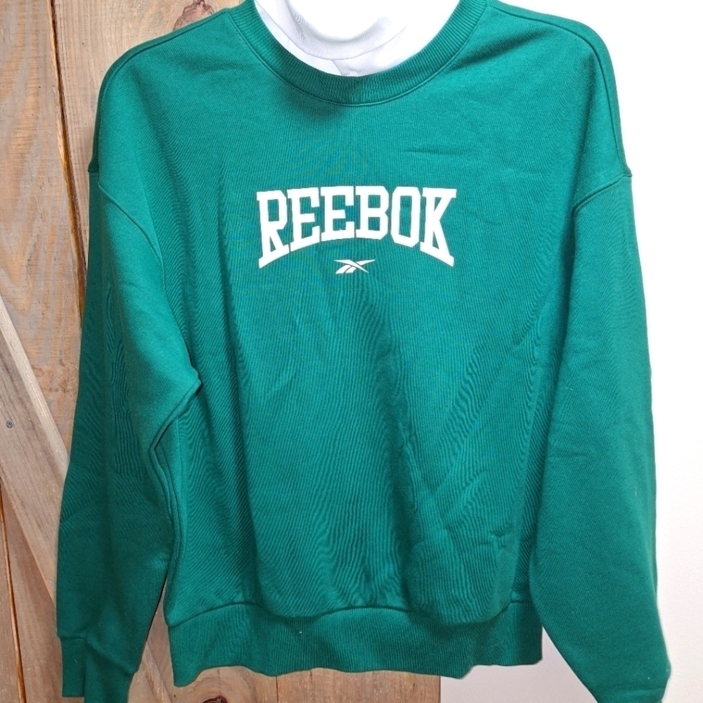 A Reebok hoodie in forest green in a womens size medium. CL BBall W/Crew.